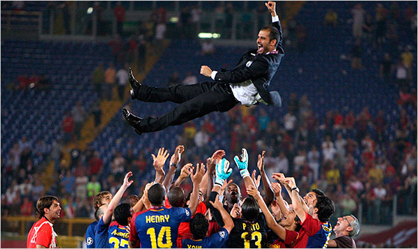 Barca Manager Pep Guardiola hoisted into the air by his players
